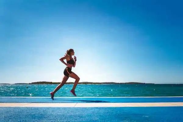 Woman running showing strong leg muscle Harlow